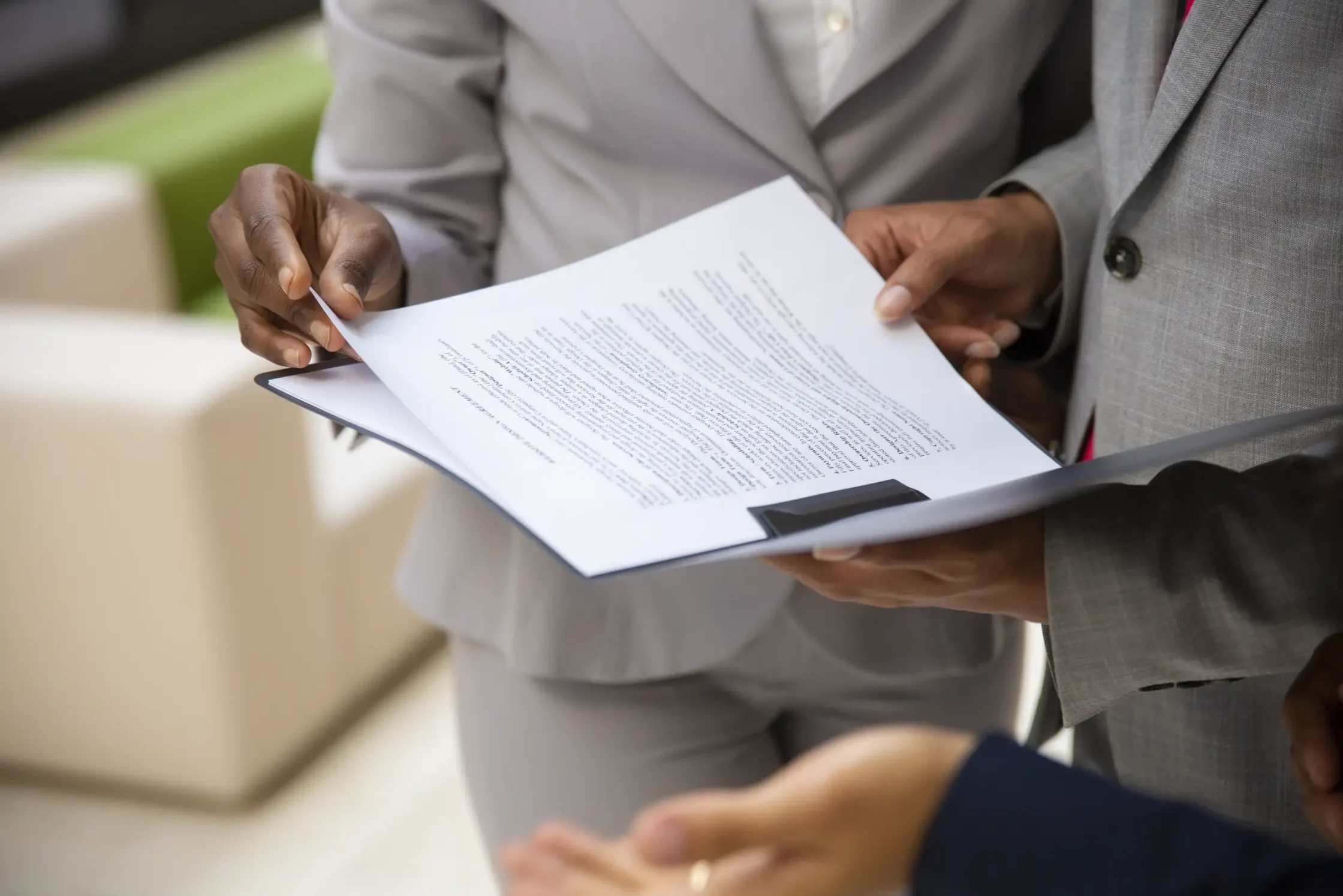 diverse business partners reading contract together